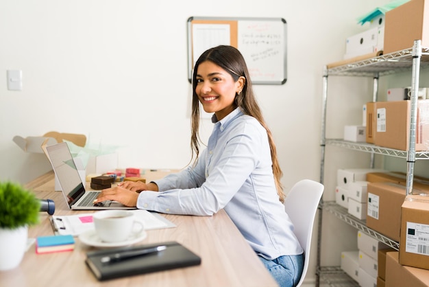 beautiful-business-owner-smiling-making-eye-contact-while-working-her-office-desk-her-online-startup-company_662251-1795.jpg